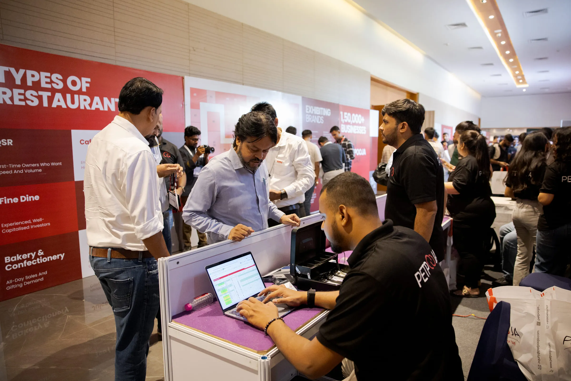 The Petpooja desk on the Conclave floor with visitors registering