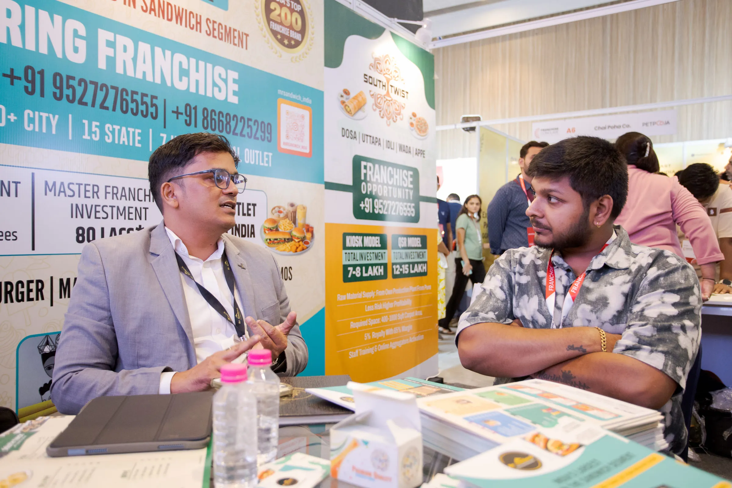 A brand founder pitching a franchise model one-to-one at their stall