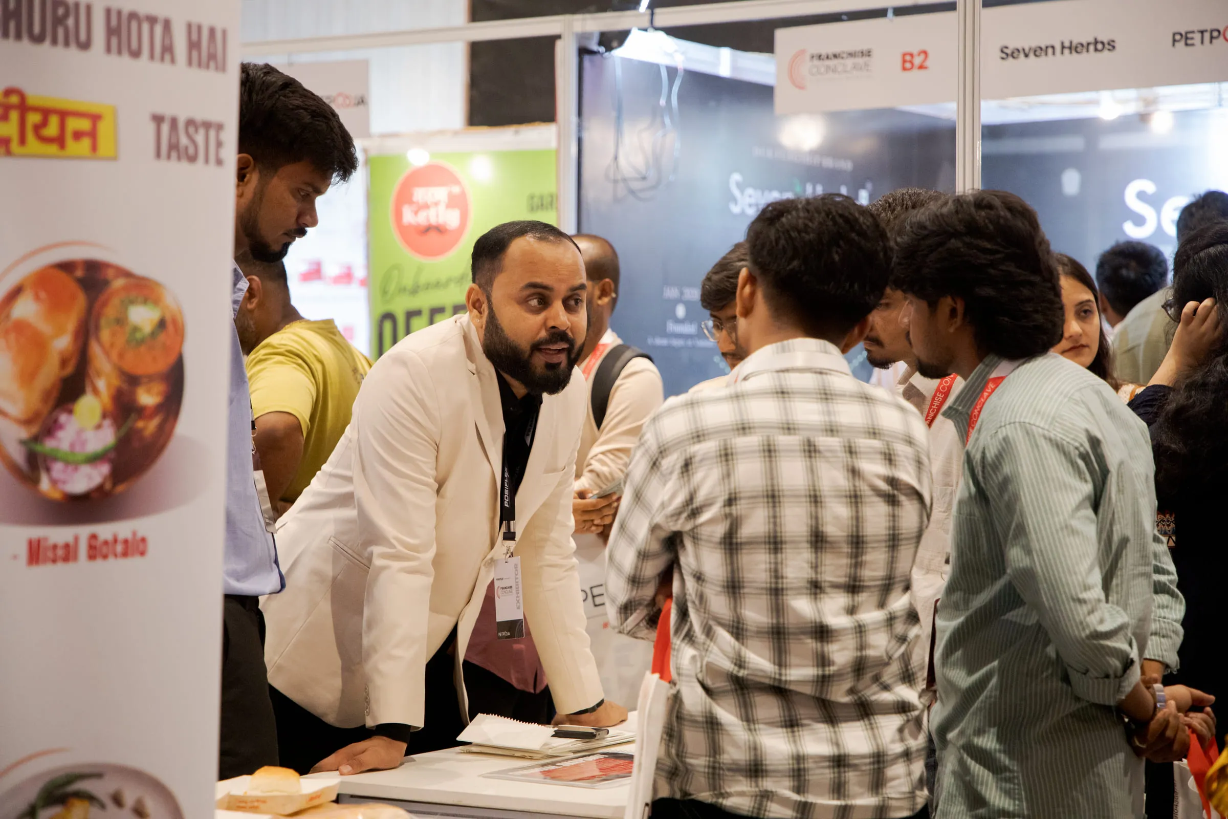 An exhibitor presenting to a group of investors at their stall